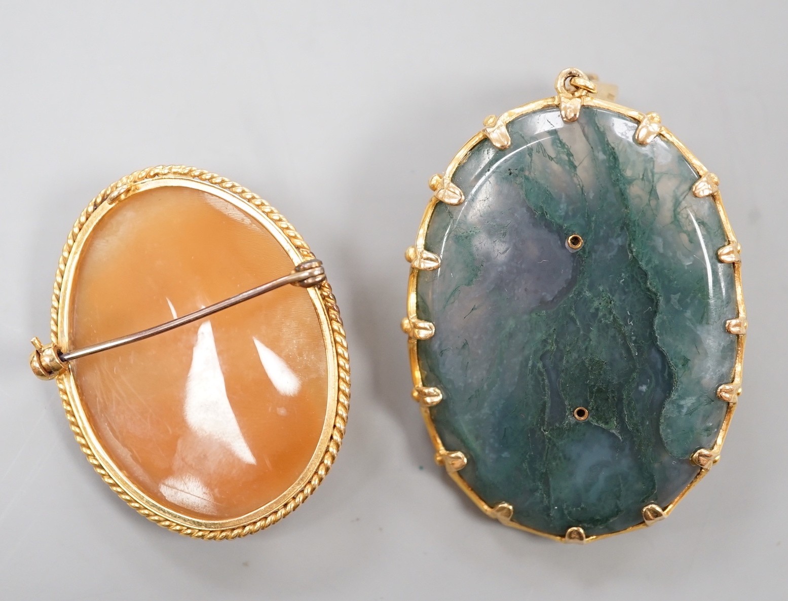 A 9ct gold and ruby mounted moss agate oval pendant with applied bust of a lady 52mm, moss agate cameo and a modern 9ct gold mounted oval cameo shell brooch, gross weight 47.6 grams.
